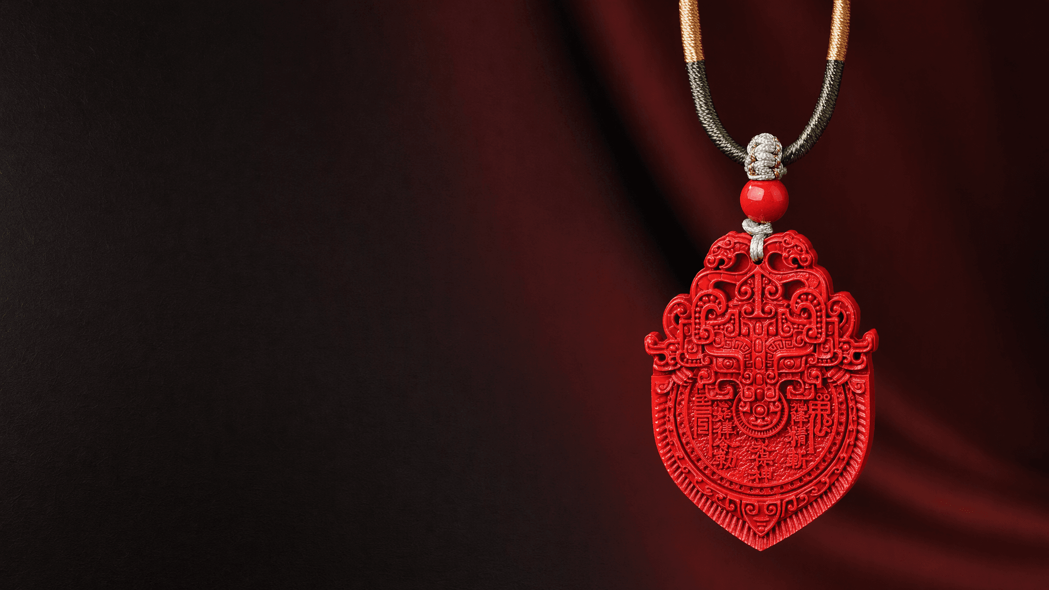 Shan Gui cinnabar guardian pendant in a refined dark red jewelry editorial setting